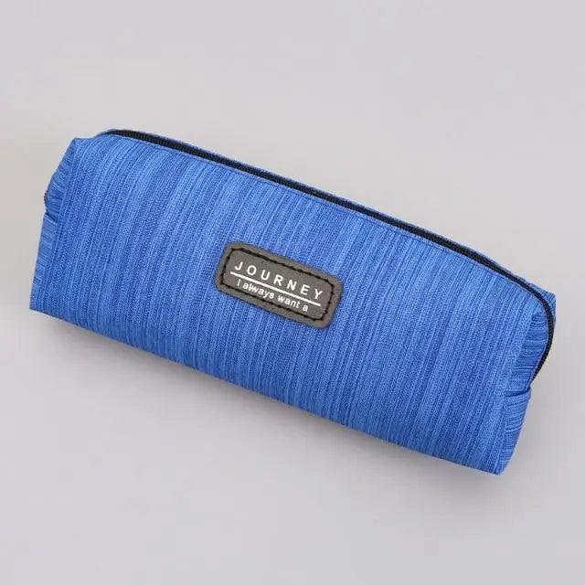 Small waterproof pencil case in bright blue fabric with zipper and centered brand patch