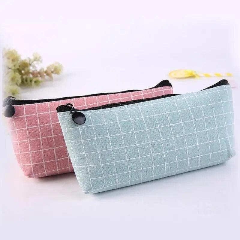 Two-grid pencil cases with black zipper: maroon and light blue, with round pull tabs.