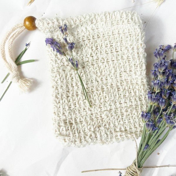 Beige sisal soap pouch with woven mesh and white cotton tassel drawstring cord.