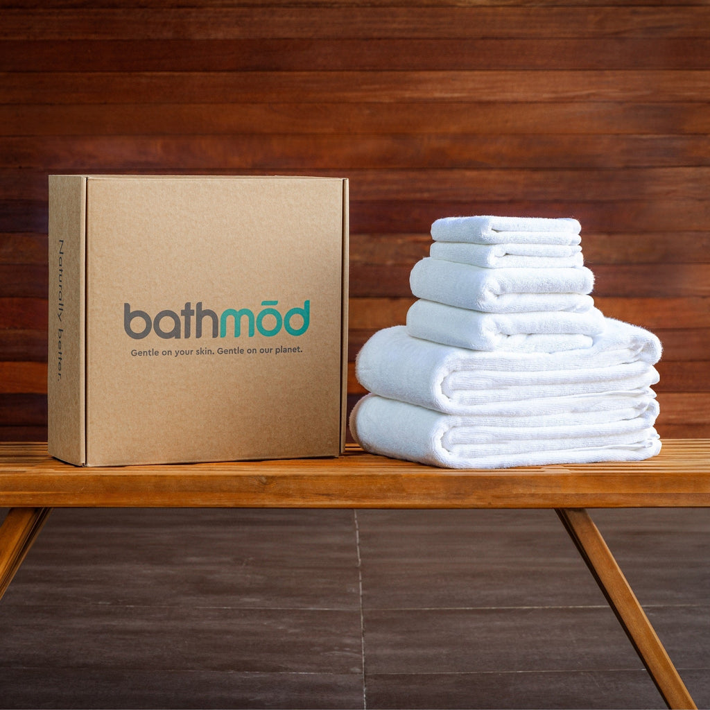 Folded light blue bath towels stack with rectangular gift box