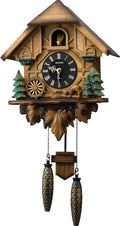 Wooden German cuckoo clock with carved pine trees and circular black dial, two weights