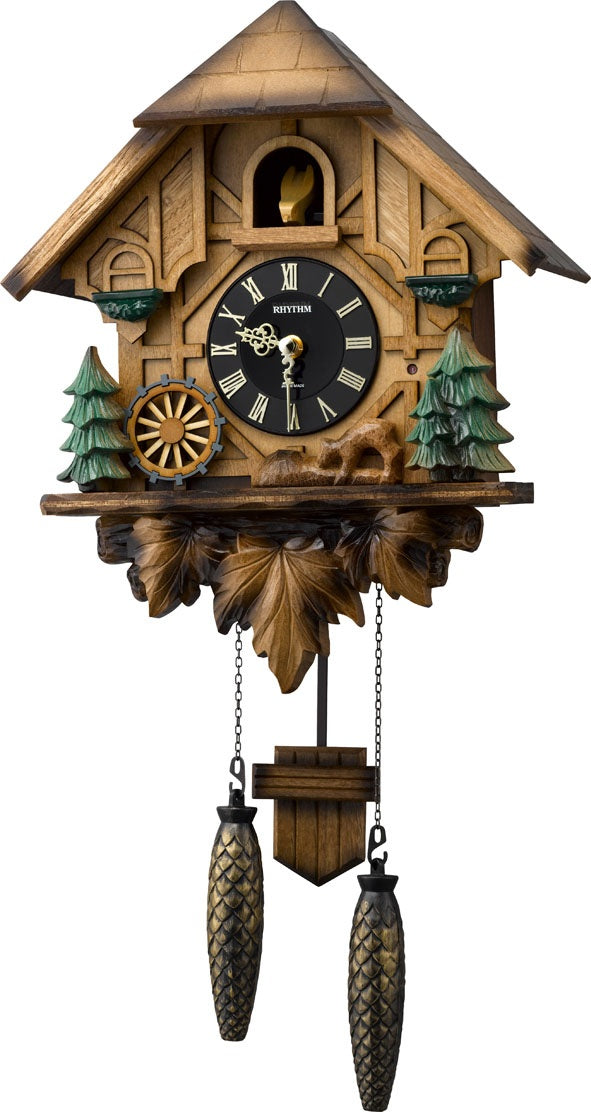 Wooden German cuckoo clock with carved pine trees and circular black dial, two weights