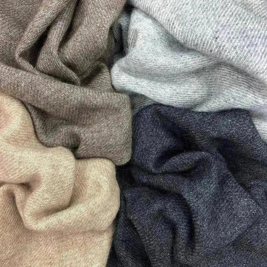 Close-up cashmere scarf weave with taupe, light beige, gray and navy folds