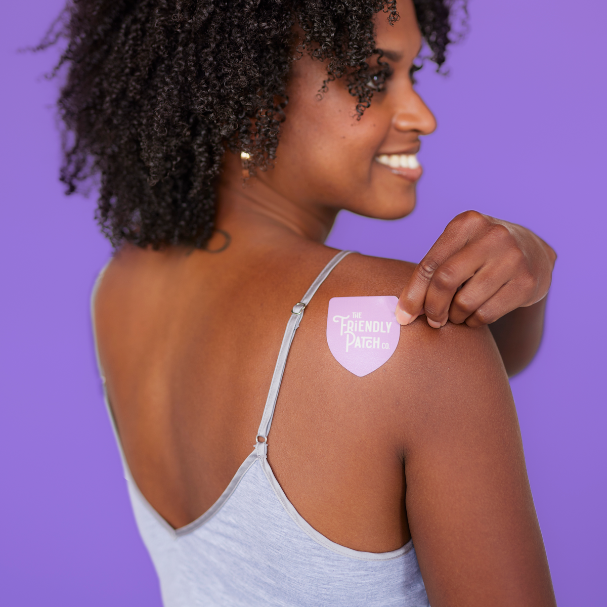 Melatonin sleep patch on upper shoulder with The Friendly Patch Co. purple shield label.