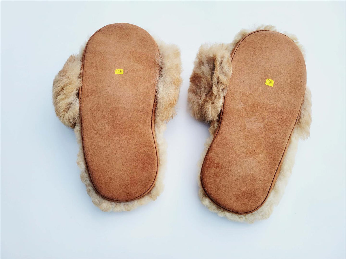 Tan fur slippers showing underside and flat sole bottoms