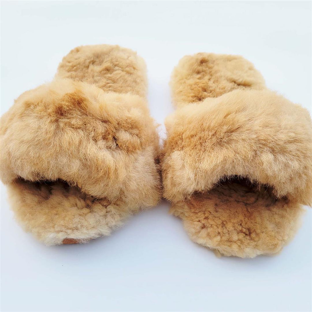 Tan plush slide-in slippers with thick furry upper and curved toe