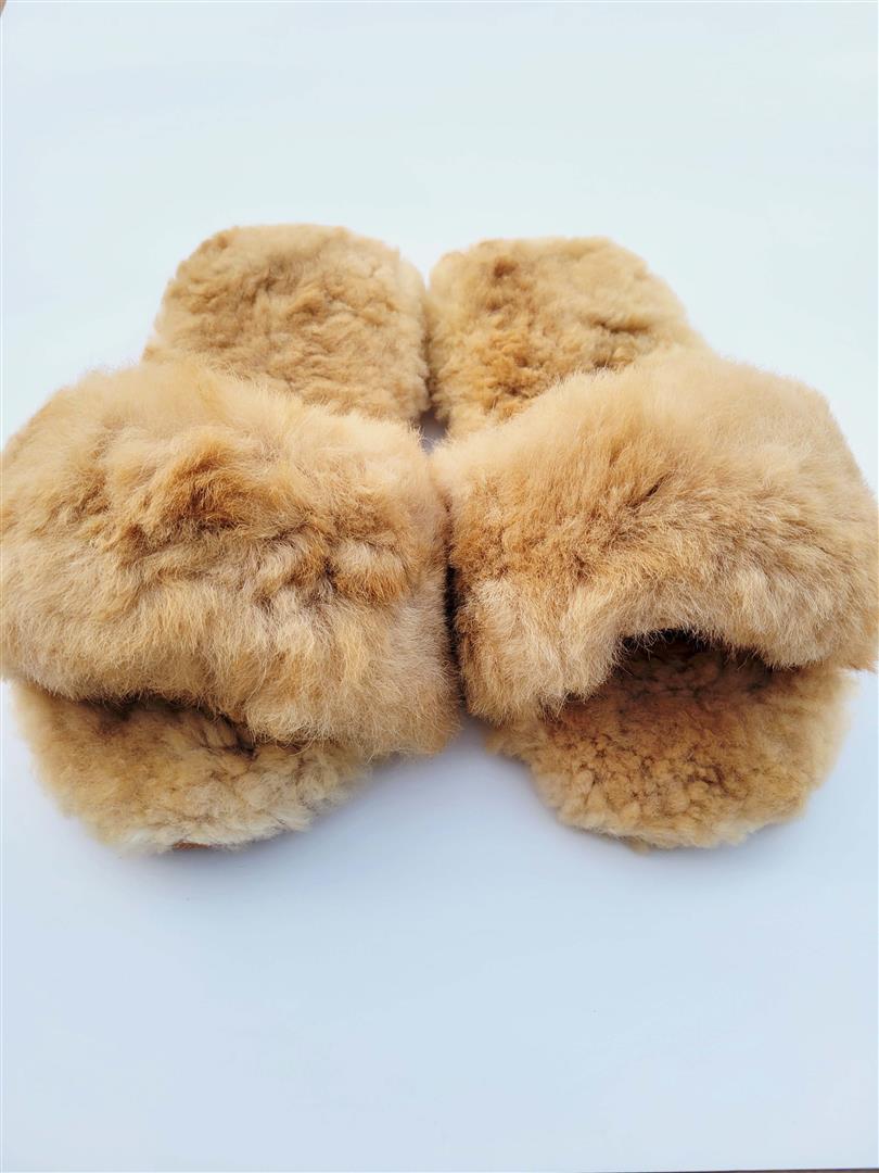 Tan fuzzy fur slippers with cushioned sole, front view
