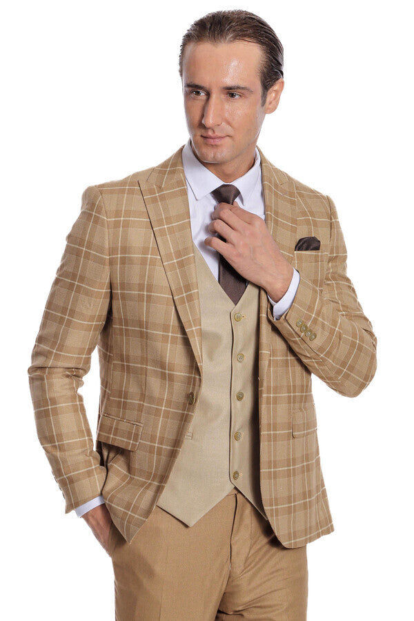 Men's checked tan blazer and beige waistcoat with dark tie, hand at collar