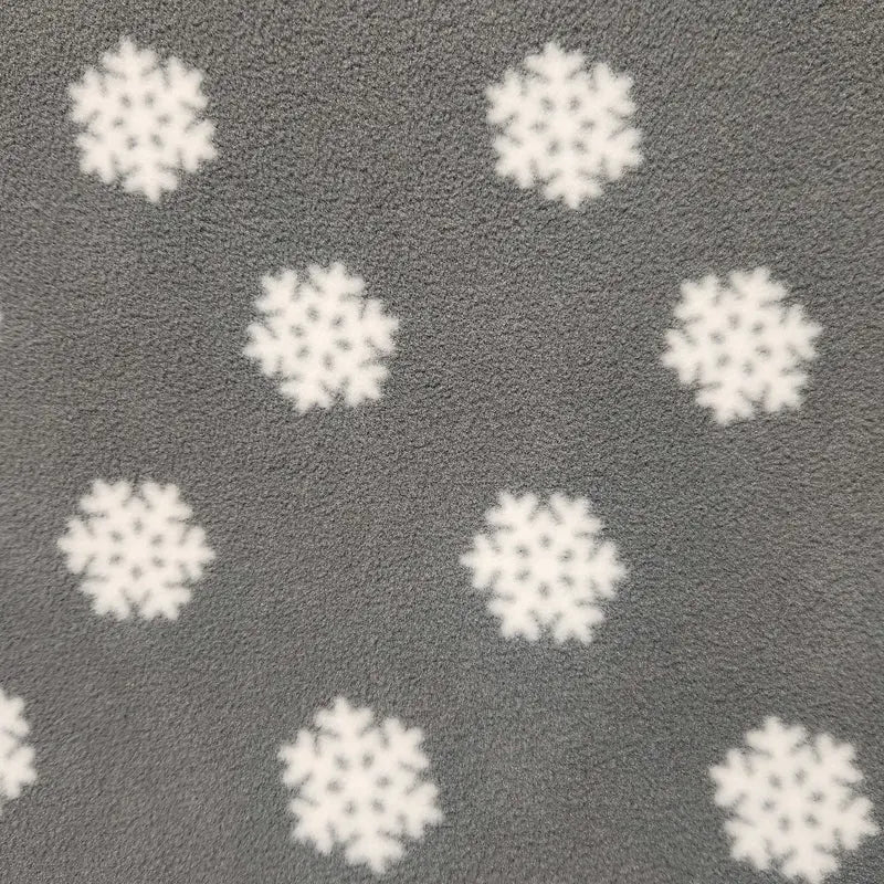 Close-up of dark gray fleece fabric with scattered white snowflake pattern