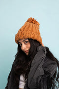 Camel chunky cable-knit beanie with folded cuff and large pom-pom