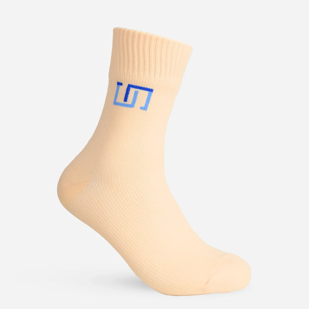 Light beige ankle socks with blue logo on the front