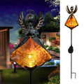 Solar LED flame stake lantern with bronze wings and glowing amber glass center light