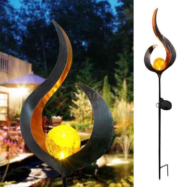Solar LED flame stake light with curved dark metal petals and glowing amber bulb