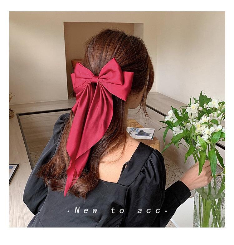 Hot pink satin bow hair clip with long ribbon tails