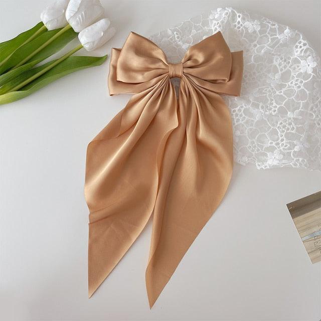 Champagne satin bow hair clip with long ribbon tails and snap barrette
