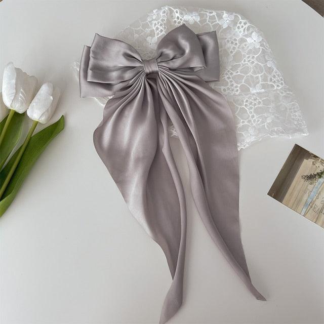 Silver satin bow hair clip with long ribbon tails