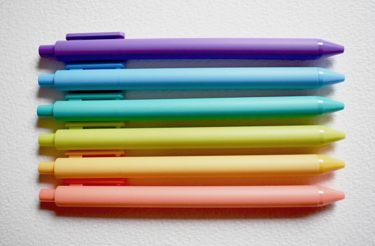 Color gel pen set with capped pens in blue, green, yellow, and orange