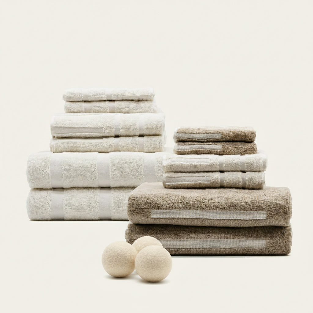 Stacked ecru and tan Australian cotton towels with subtle stitched stripe bands.