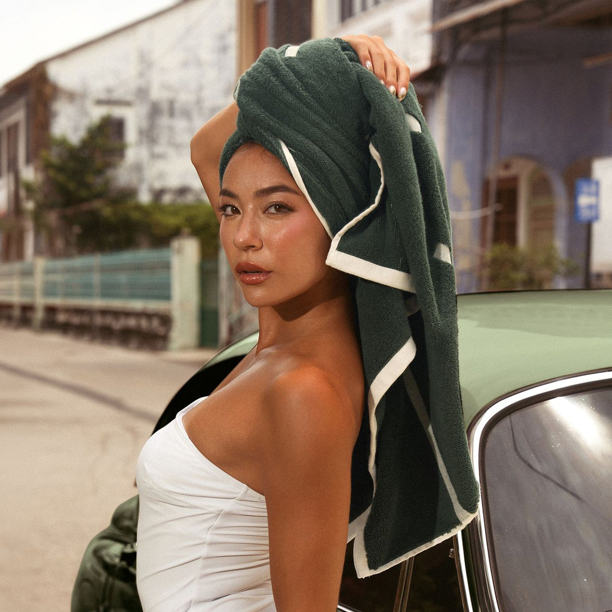 Dark green cotton towel set as a head wrap with white border stripe accents.