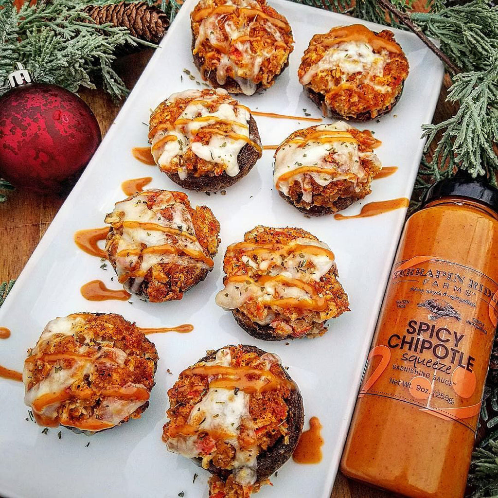 Spicy chipotle squeeze bottle beside cheese-topped meatballs on a platter