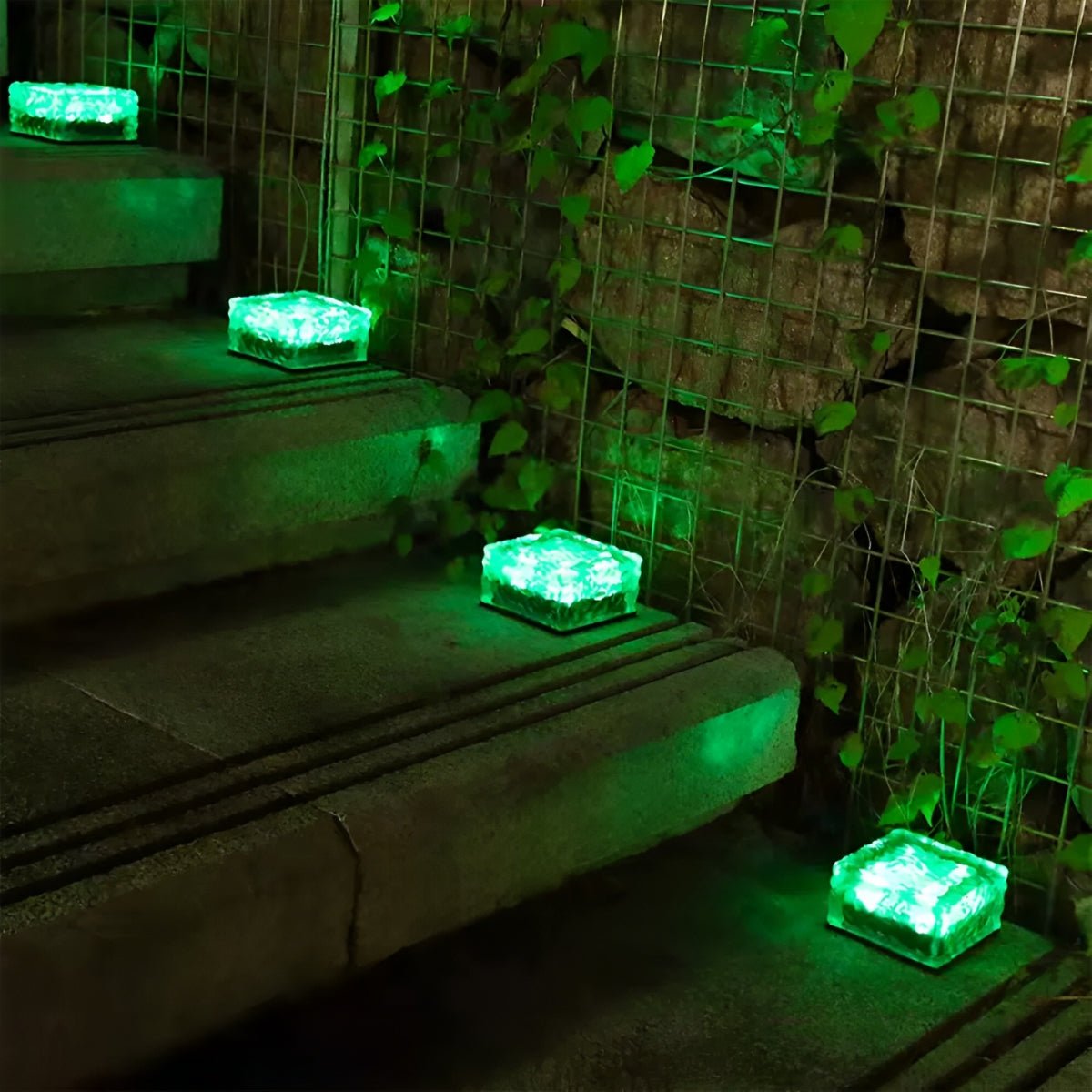 Solar LED ice brick path light with green glow, square top, outdoors on steps
