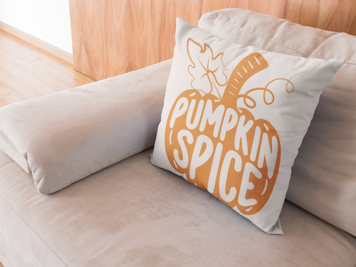 Beige sofa throw pillow with orange pumpkin spice front graphic