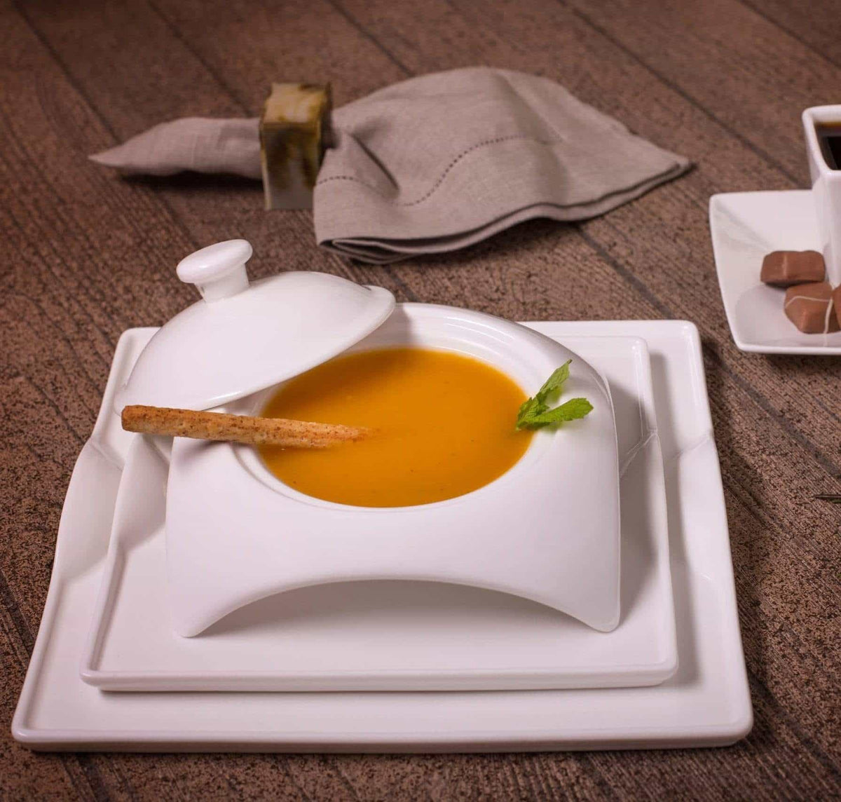 White square porcelain soup plate with textured rim and matching base