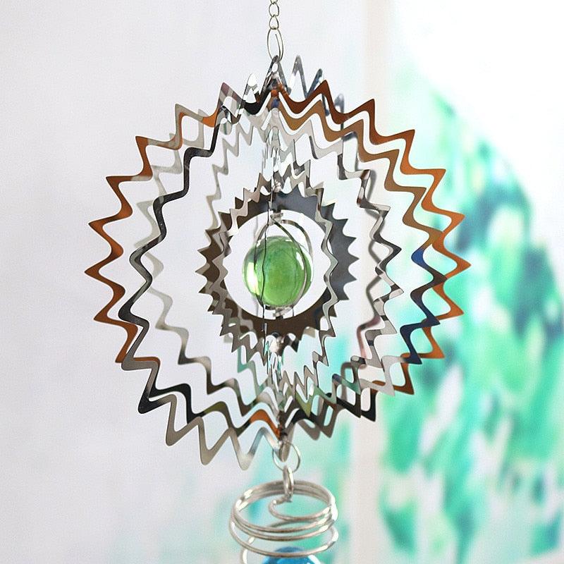 Starburst metal wind chime pendant with green glass orb, spiral rings, and clear crystal