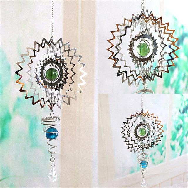 Starburst metal wind chime with green center, patterned cutouts, blue bead, and clear drop