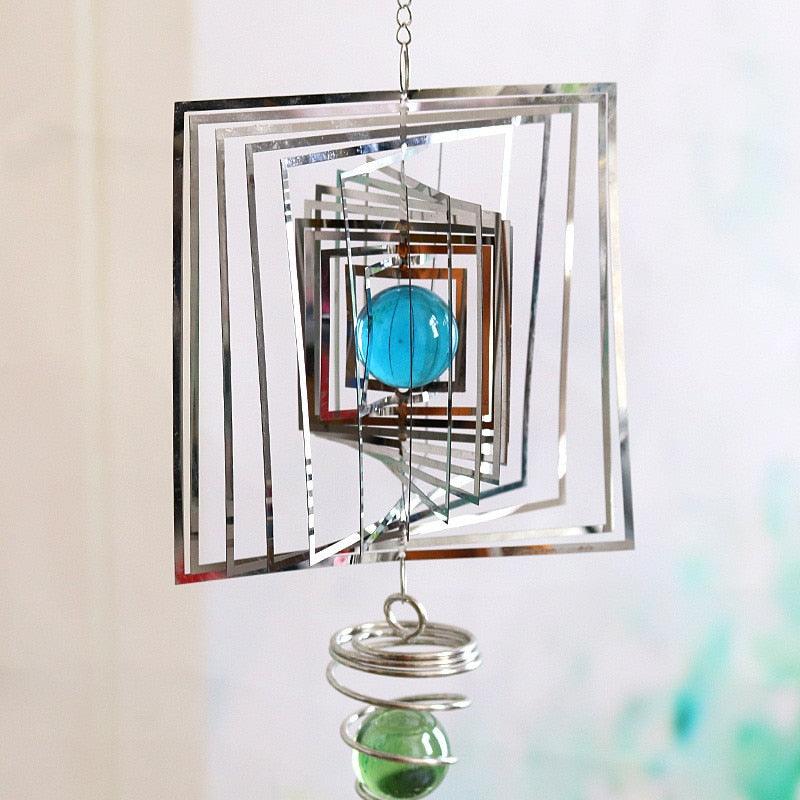 Square mirrored metal wind spinner chime with blue glass sphere and stacked rings