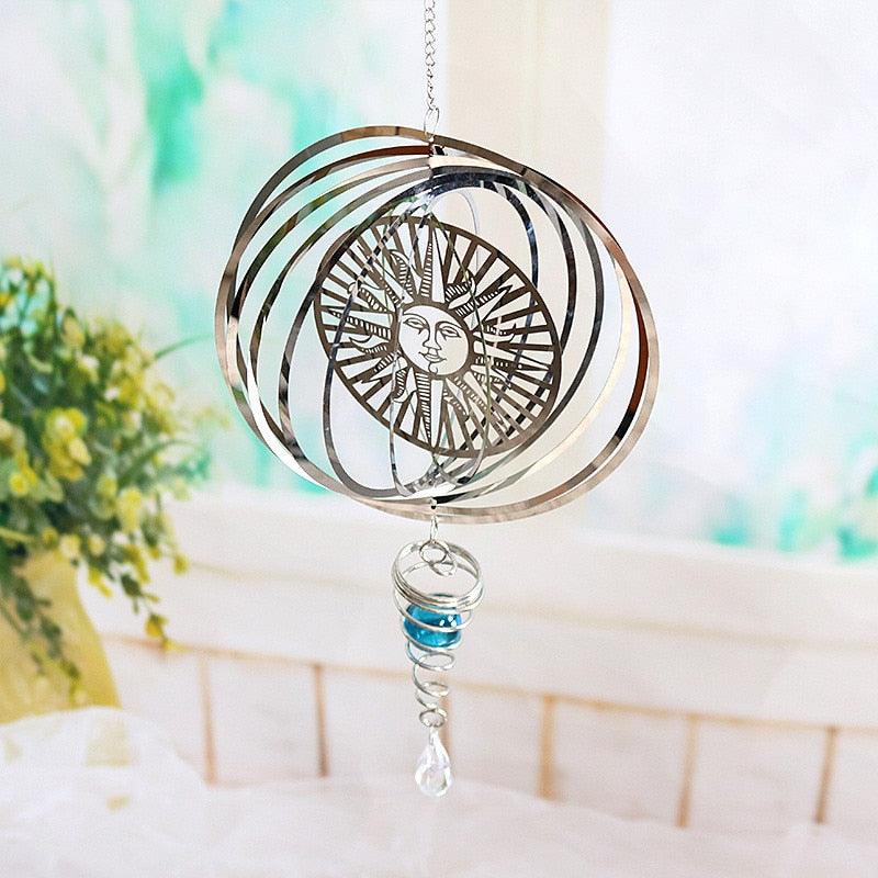 Spiral ring metal wind chime pendant with sun face, blue bead, and clear crystal drop
