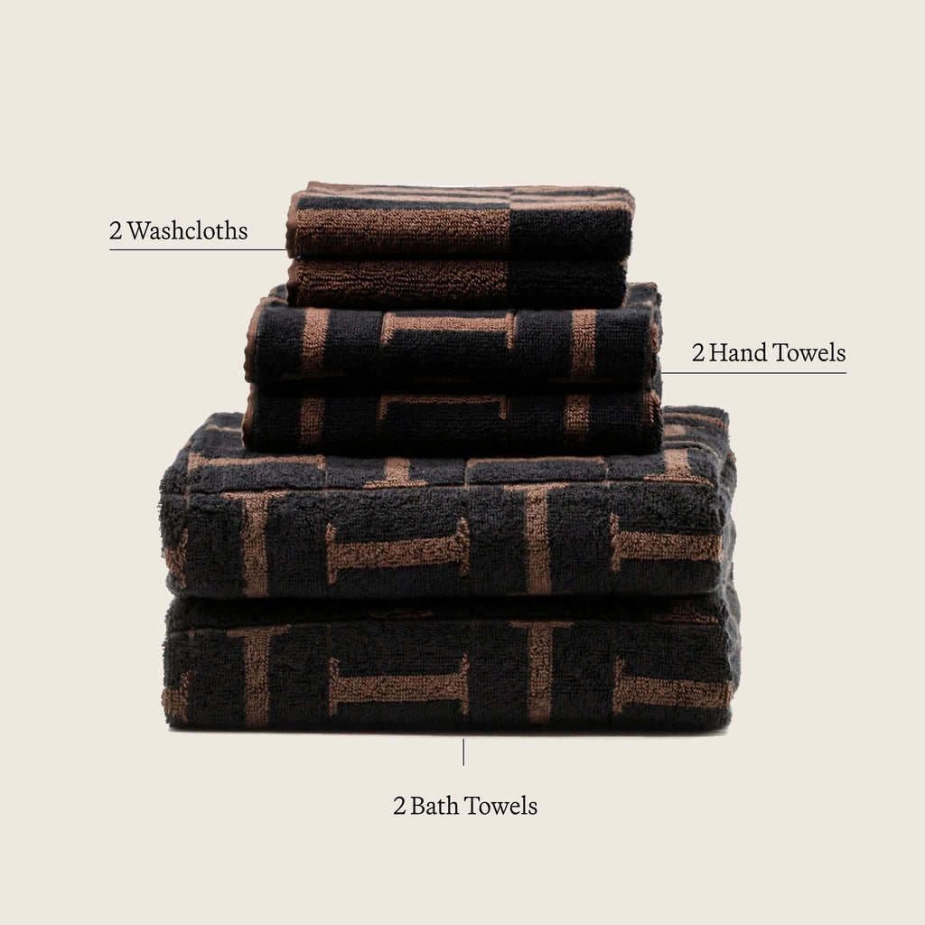 Cotton towel stack in tobacco and black with woven stripe pattern; 2 washcloths and 2 hand towels
