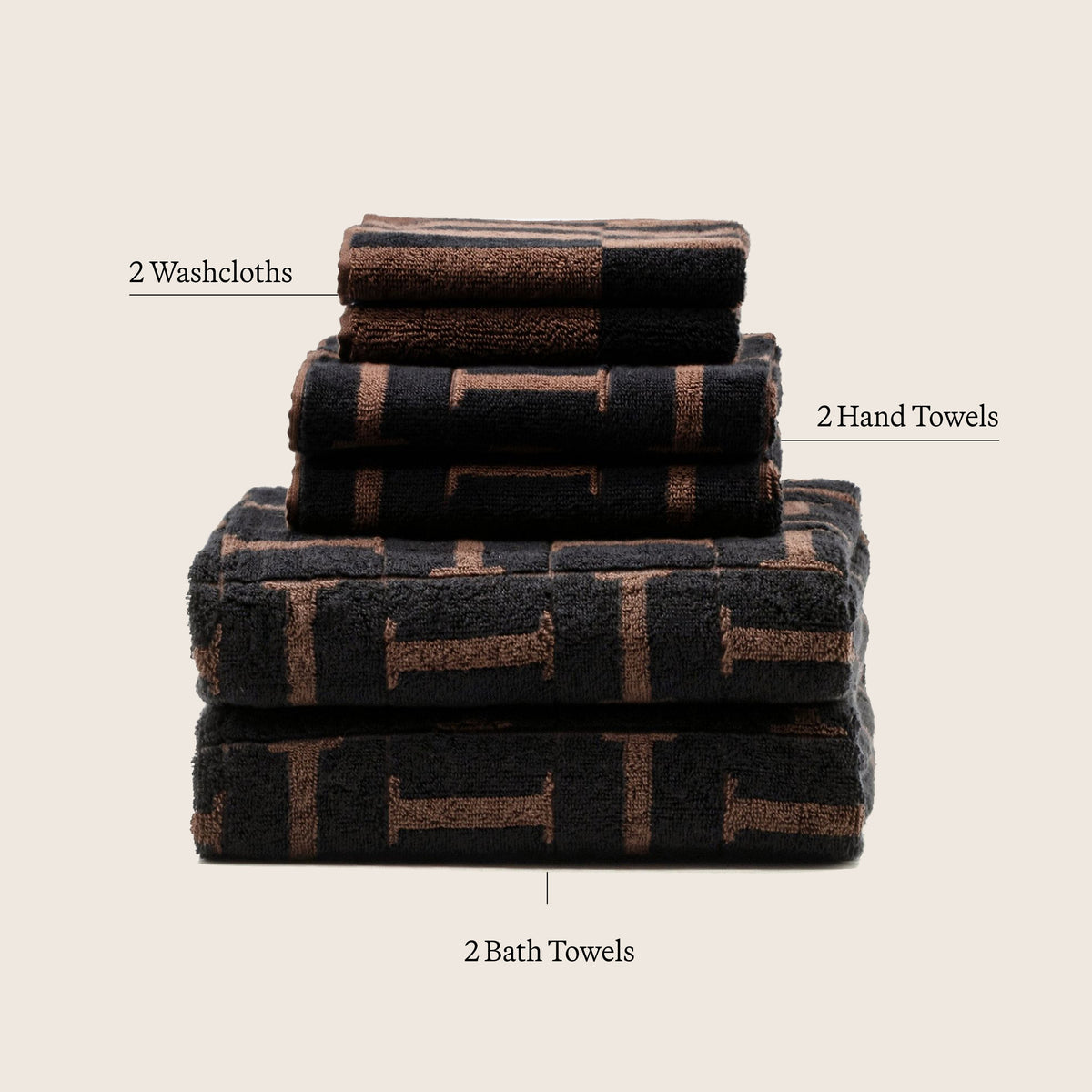 Cotton towel stack in tobacco and black with woven stripe pattern; 2 washcloths and 2 hand towels