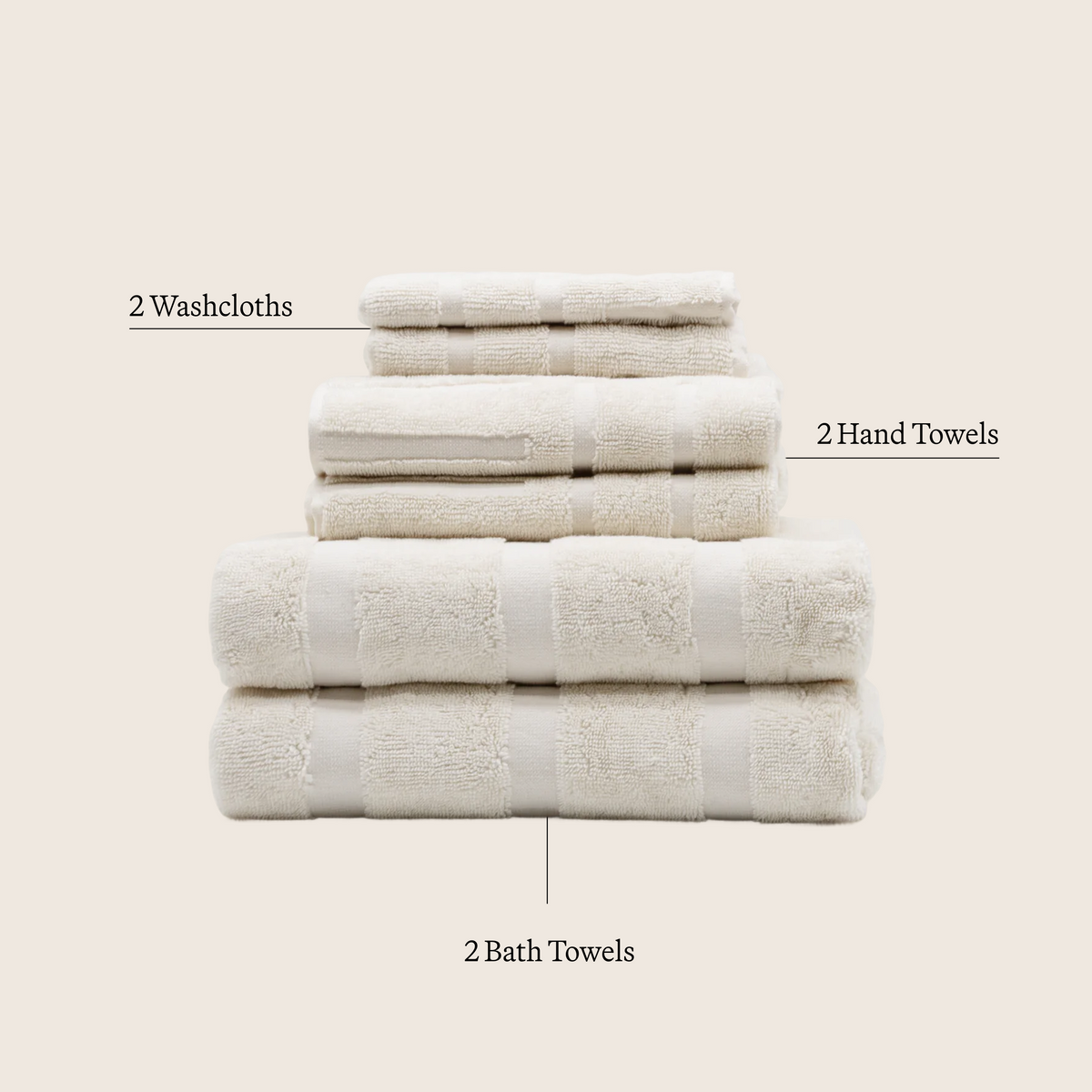 Ecru cotton towel stack with embossed grid texture and neatly folded edges