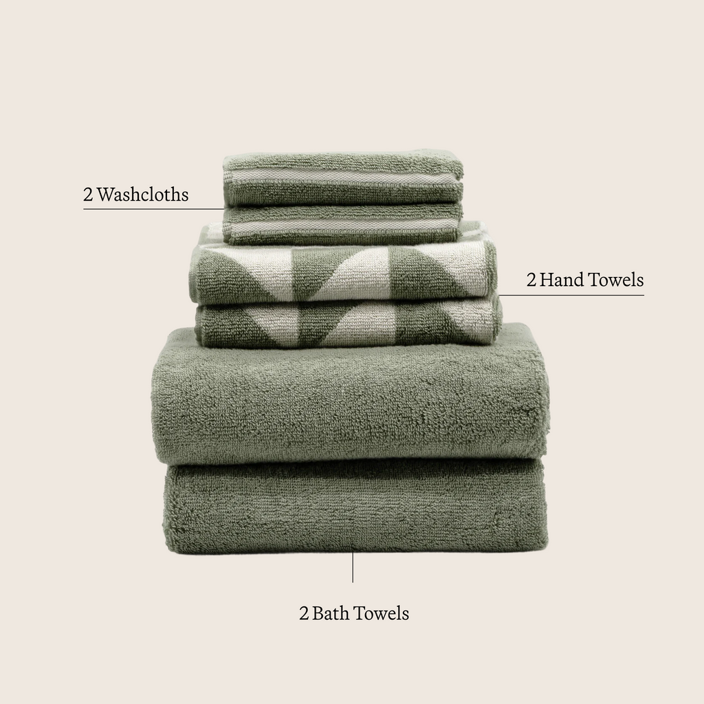 Cotton towel set in sage green and ecru, stacked washcloth, hand towel, and bath towel