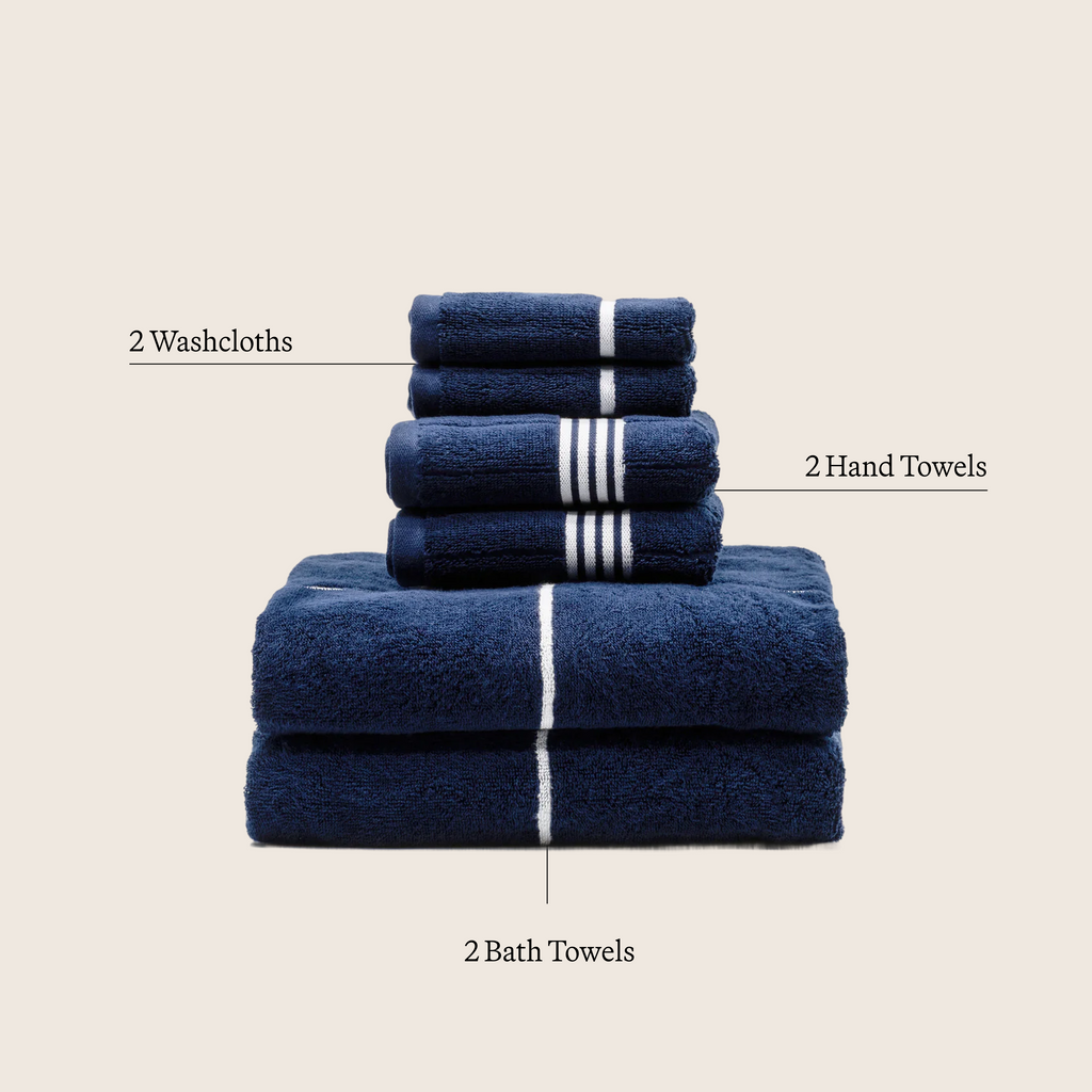 Navy and white striped cotton towels stacked with white bands