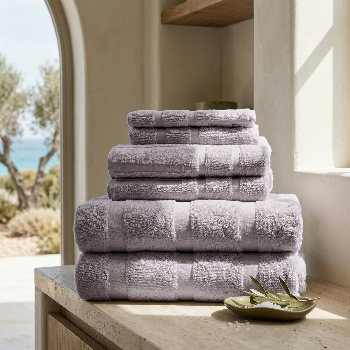 Lilac cotton towels stacked in neat columns for display