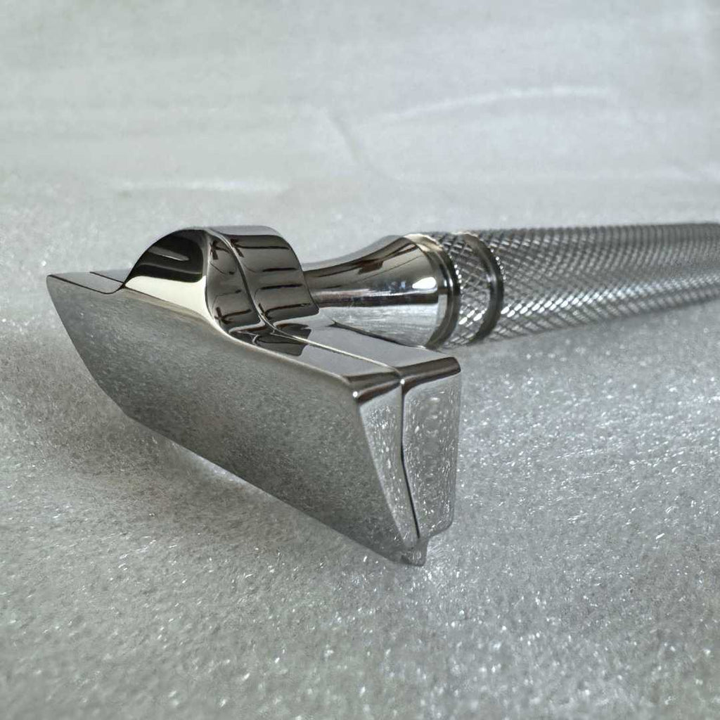 Close-up of double-edge safety razor head and knurled handle