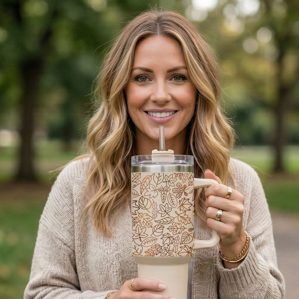 40 oz fall-themed tumbler with lid and straw, cream base with orange leaf pattern