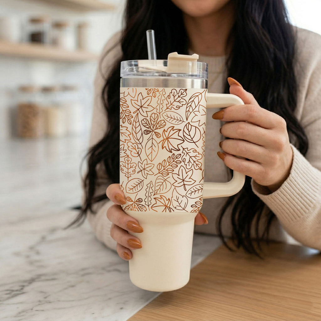 40oz cream tumbler with clear lid and straw, orange leaves line pattern.