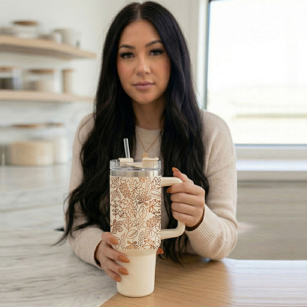 40 oz tumbler with lid and straw, cream color with orange autumn leaf graphic