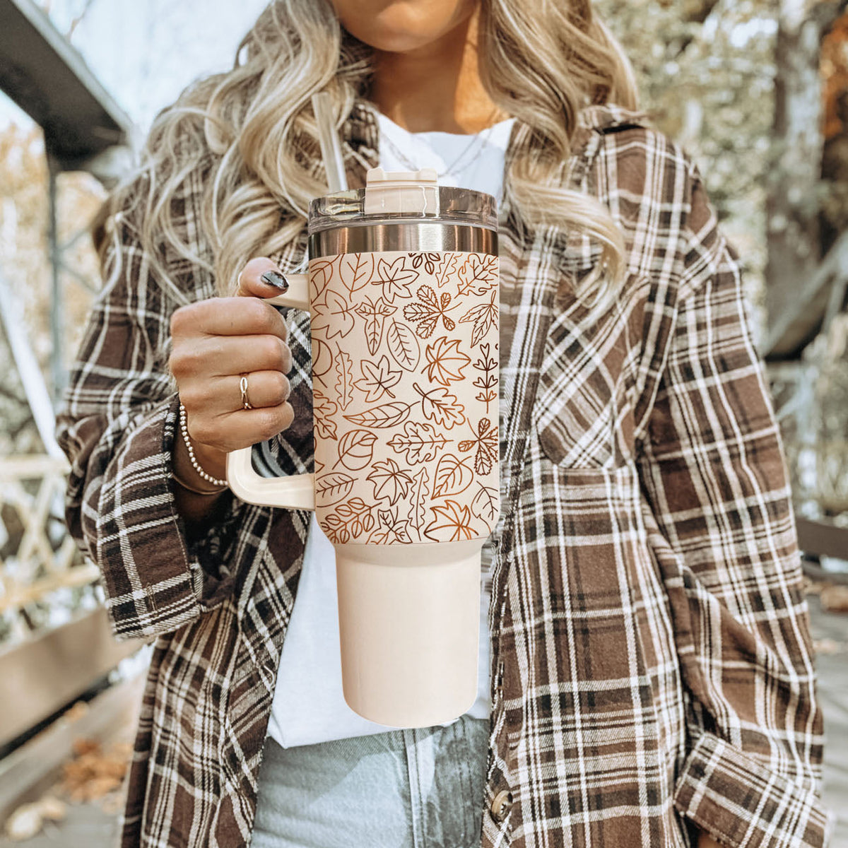 40oz cream tumbler with clear lid and straw, orange botanical line leaves.