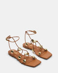 Cognac leather flat sandals with open toe, thin straps, and gold-tone round studs