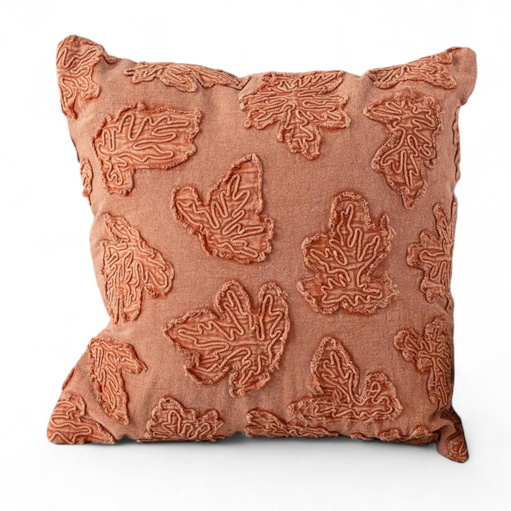 Orange stonewashed throw pillow with raised leaf embroidery, square