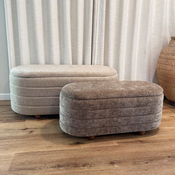 Two upholstered nesting storage benches with light beige and dark gray rounded tops