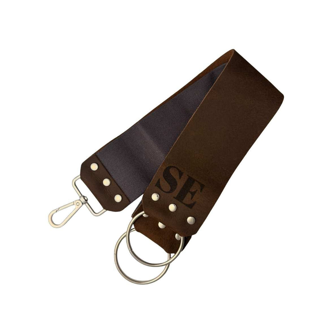 Dark leather razor strop cover with snap and metal hanging ring