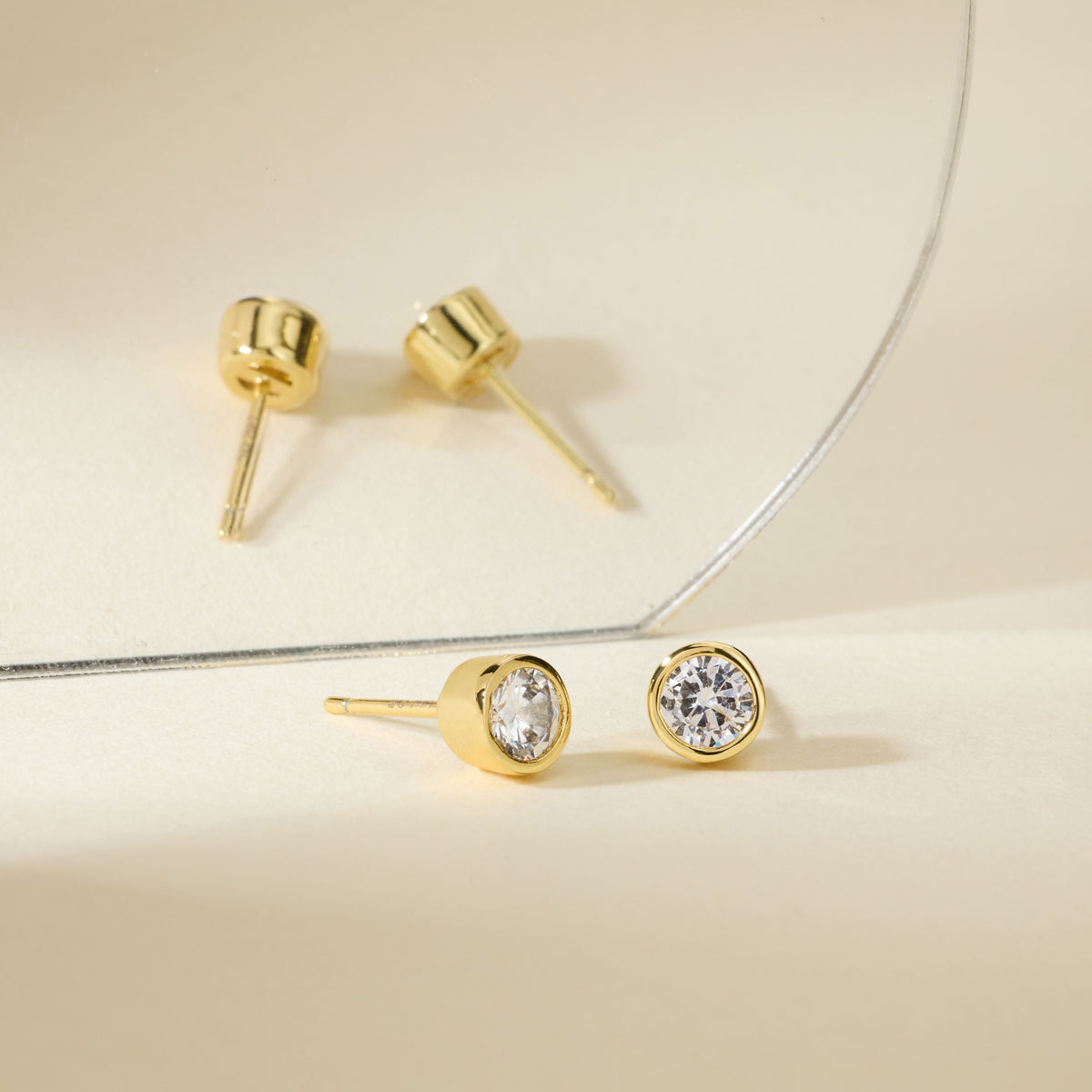 Gold round diamond bezel stud earrings with posts and flat backs