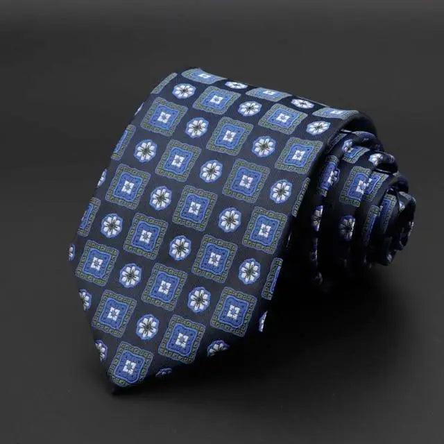 Navy tie with blue geometric squares and white floral motifs