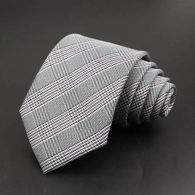 Gray houndstooth woven tie with fine white grid pattern