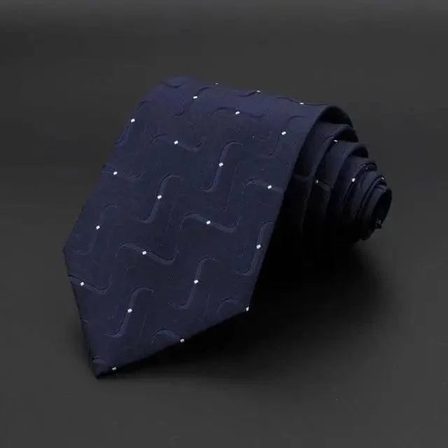 Men's necktie in dark blue with small raised swirl pattern on woven fabric.